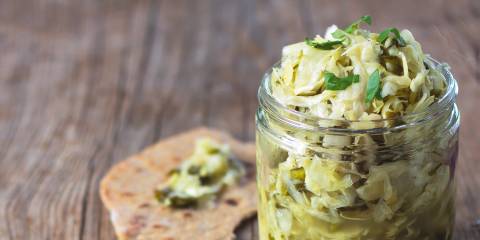 A jar of taco kraut with a piece of flatbread
