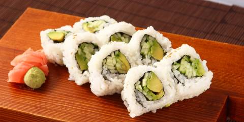 vegan maki rolls on a board with ginger and wasabi
