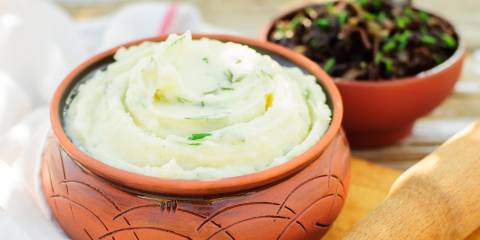 a bowl of mashed potatoes and herbs