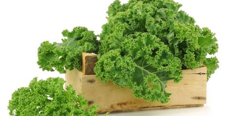 Kale with Carrots Kale in a wooden basket