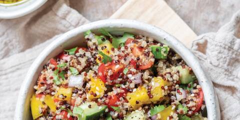 Quinoa Tabbouleh Top view of Quinoa Tabbouleh in a white bowl on flour sack cloth.