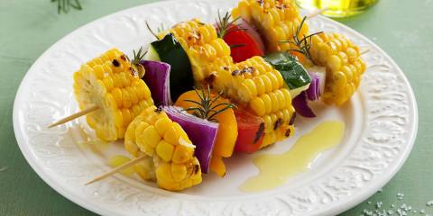 Vegetable Kebabs with Smoked Paprika a plate of grilled vegetables on skewers with oil and seasoning