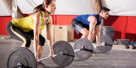 Man and a woman lifting weights. 