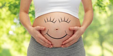 A Chemical-Free Pregnancy a pregnant woman with a smiley face drawn on her bump