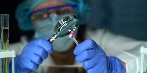 a scientist testing and examining supplements