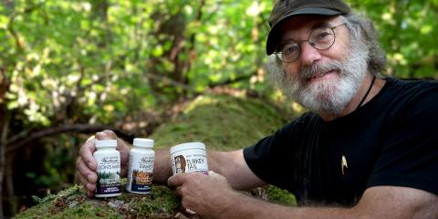 Paul Stamets holding Host Defense packaging