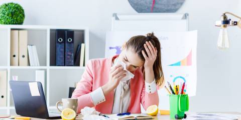 a young woman sick but at the office anyway