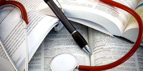 How to Read and Interpret Health Studies a pile of medical journals and references