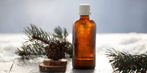Winter Wonderland Aromatherapy Spray an aromatherapy bottle surrounded by springs of pine and pinecones