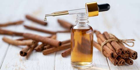 cinnamon bark and a bottle of oil