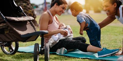 young mothers introducing their kids and babies at the park