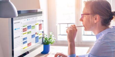 Person looking at their schedule on a computer. 