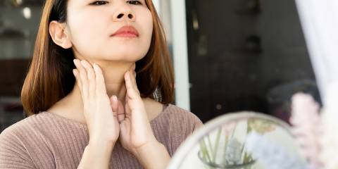 Lymph Massage with Essential Oils a woman rubbing her nodes on her neck below her jaw