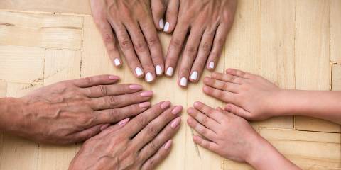 Supplements by Life Stage different generations of a family touching hands