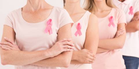a row of proud breast cancer survivors