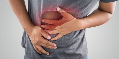 a man holding his liver in pain