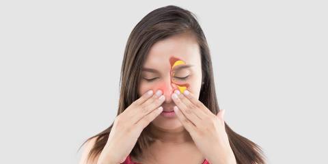 a young woman massaging her sinuses