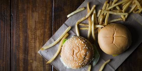 Burgers and fries on a greasy wrapper
