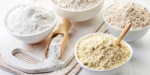 bowls of different kinds of gluten-free flour for baking