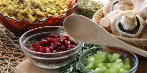 Ingredients to make healthy Thanksgiving side dishes, cranberries, bread for stuffing, celery and mushrooms.