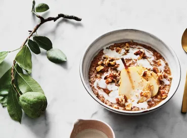 a bowl of pear porridge and a dish of honey