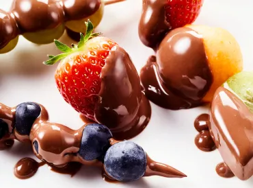 melty chocolate all over fresh strawberries, blueberries, kiwis, and mango