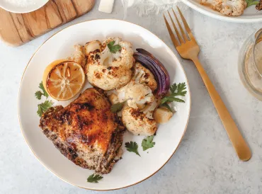 spicy chicken plated with lemon and onion