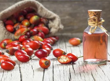 dried rosehip fruit and a bottle of rosehip oil