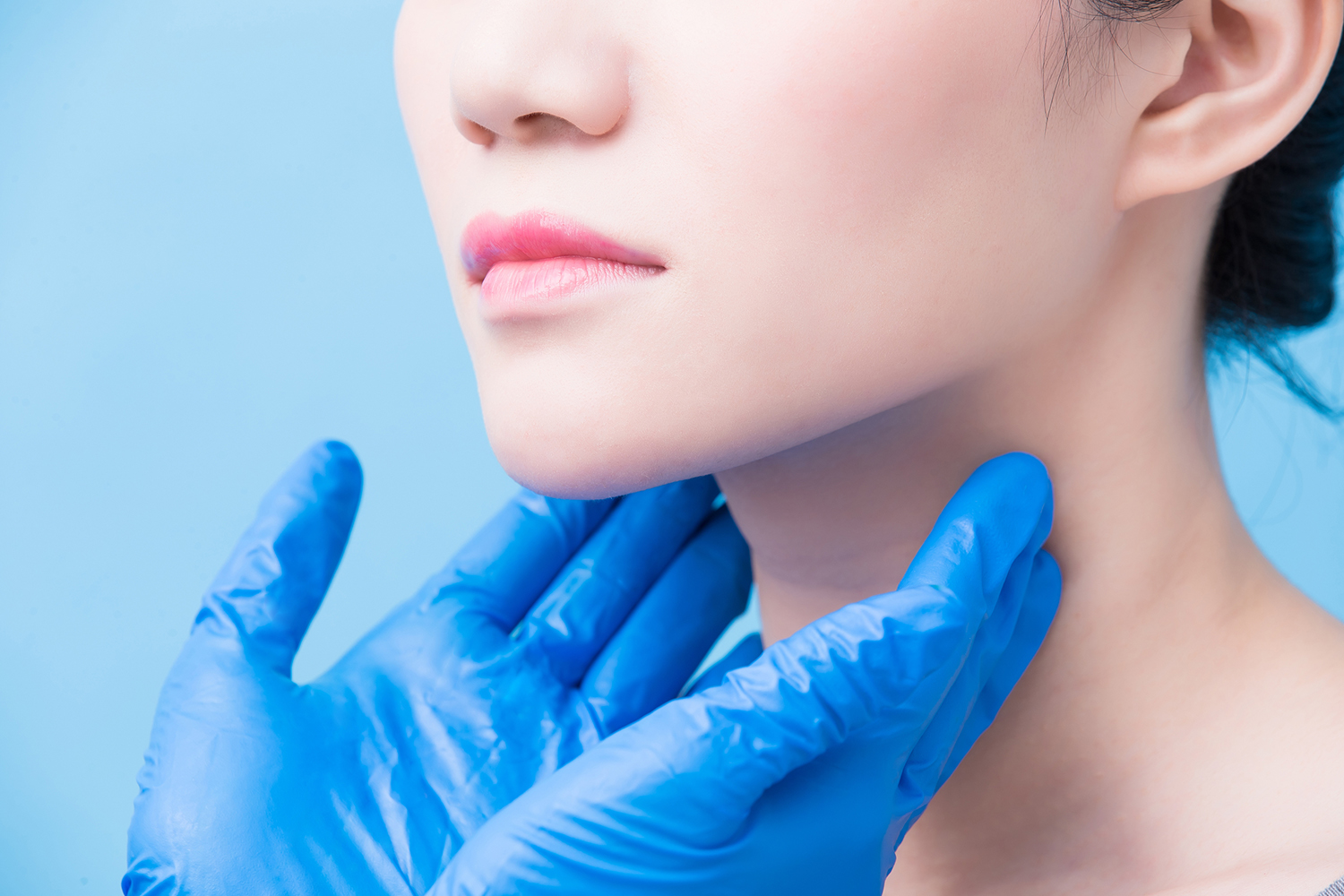 a woman having her thyroid glands checked