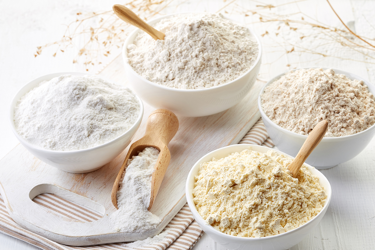 bowls of different kinds of gluten-free flour for baking