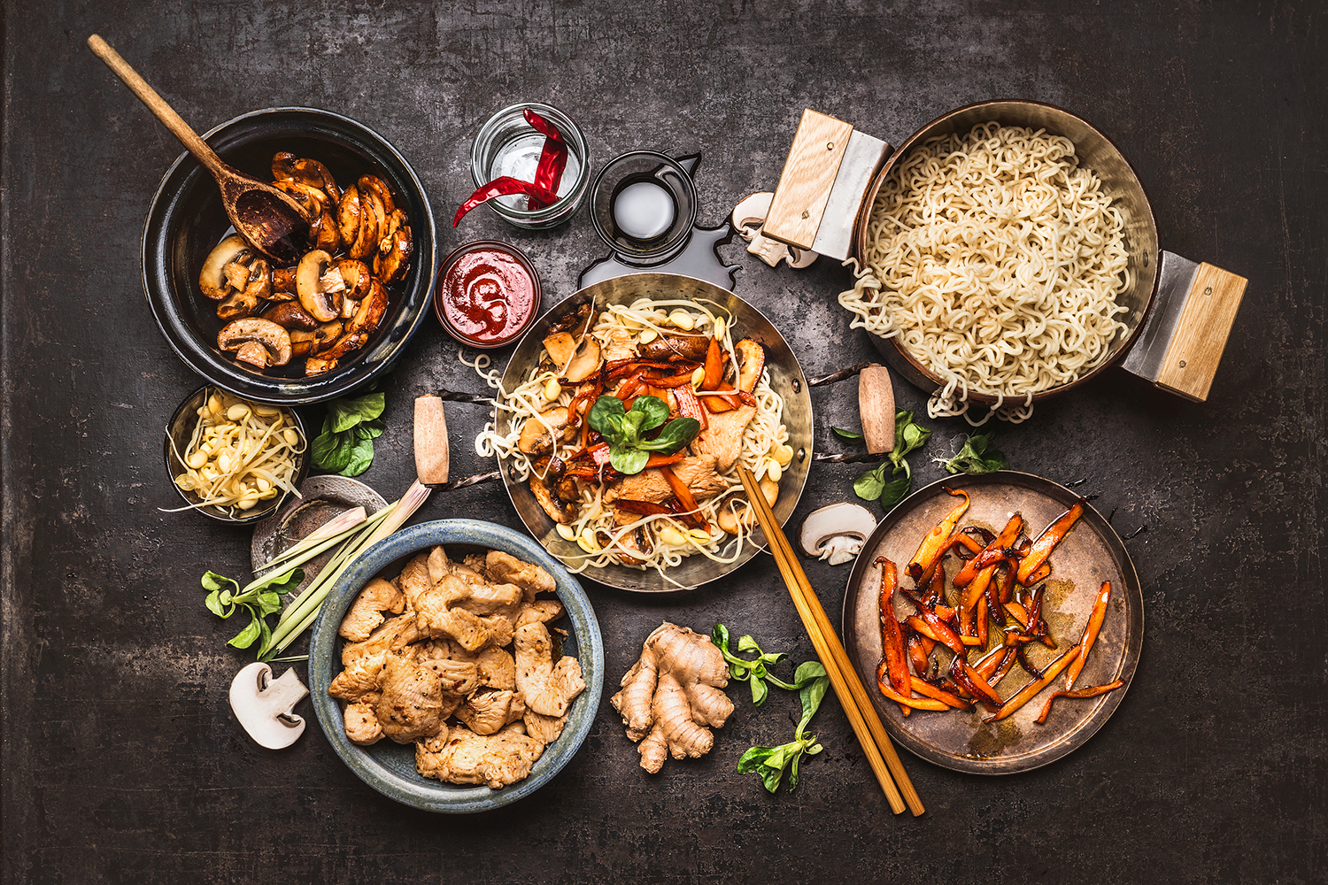 ingredients, pans, and tools for making a stir-fry
